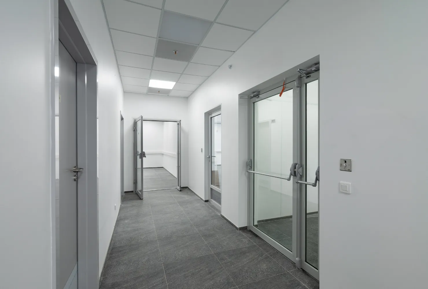 Professional interior commercial painting of a large open office space with white walls, columns, and finished ceilings