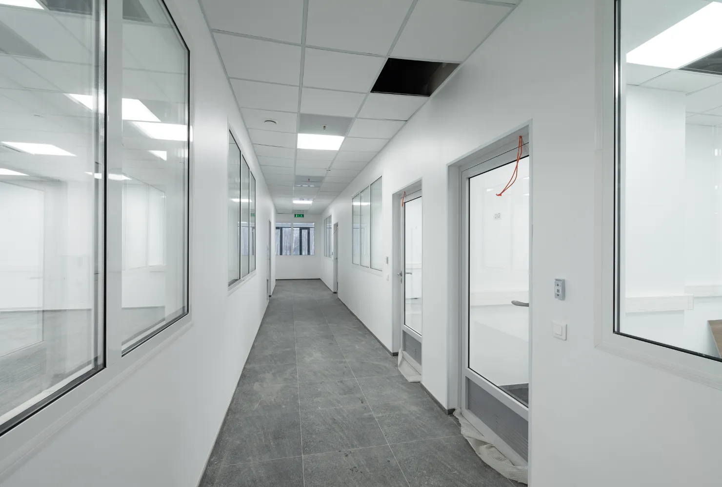 Interior commercial painting of office hallways with clean white walls, doors, and professional finish