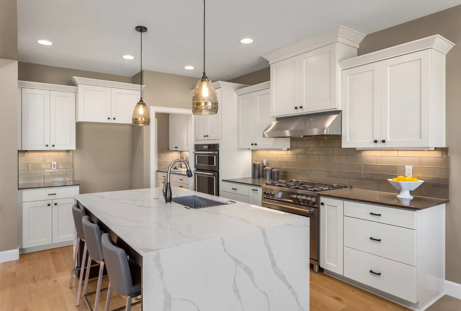 Professional kitchen cabinet painting with white shaker-style cabinets and updated hardware for a clean modern look.