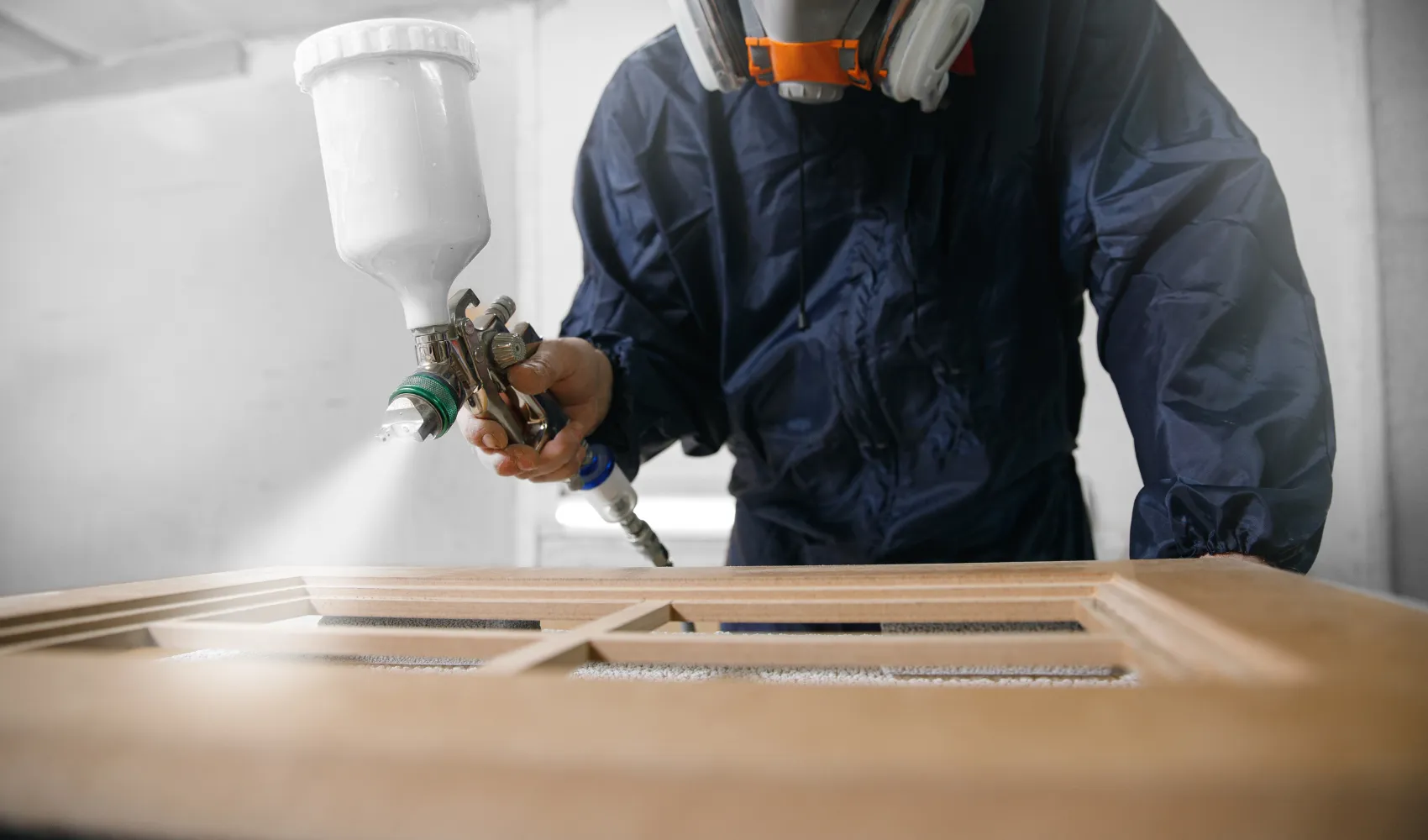 Professional cabinet painting service in Los Angeles using precision spray equipment for smooth, even cabinet finishes.