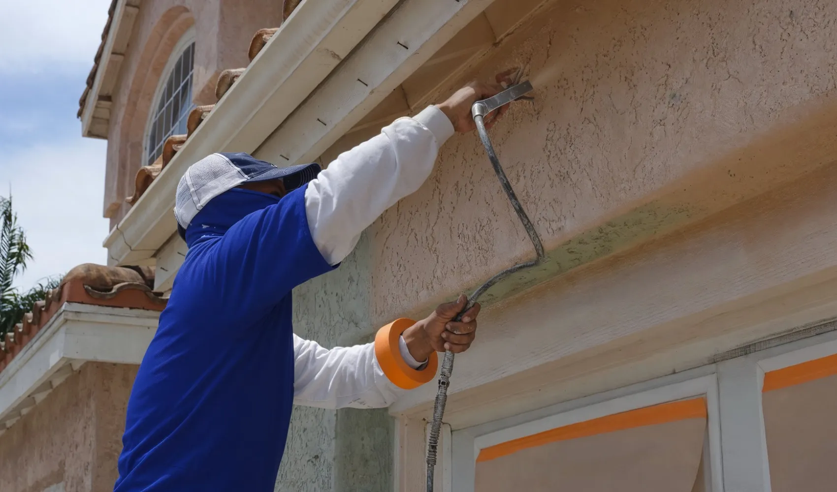 Residential interior painting service focused on clean wall edge and window frame painting